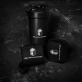 Blackspire shaker bottle, wrist wraps, and pouch on a dark textured surface